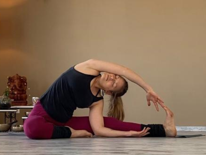 Woman-in-yoga-studio-completely-surrenders-to-the-yoga-pose-PARIVRTTA-JANU-SIRSASANA
